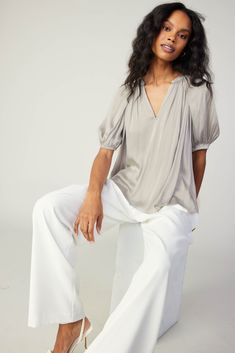 Sophisticated and effortless, this split-neck blouse showcases an easy drape with soft gathers and elegant fold detailing at the shoulders. It's lightweight and airy in a relaxed silhouette that's framed by gently puffed half sleeves. You'll wear it all year round. "•Split neckline •Band collar •Gathered detailing •Half sleeves with elasticized cuffs •Relaxed fit Item number 2430011 100% Polyester Gentle cycle cold Chic V-neck Top With Gathered Waist, Relaxed Fit Tops With Gathered Sleeves And Button-up, Luxury V-neck Blouse With Gathered Sleeves, Chic V-neck Top With Gathered Neckline, Relaxed Fit Rayon V-neck Blouse, Modern Monochrome, V Neck Blouse, Vacation Dresses, Print Trends