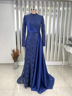 It is a lined, lace front draped dress.  It is made of 100% lace and satin fabric.  It is a lapel dress.  It is 152 cm long. Long Evening Dress With Lace Sleeves, Blue Long Sleeve Lace Gown, Fitted Long Sleeve Evening Dress For Ceremony, Blue Long Sleeve Abaya For Party, Elegant Fitted Blue Abaya, Blue Lace Long Sleeve Evening Dress, Blue Long Sleeve Lace Evening Dress, Blue Lace Evening Dress With Long Sleeves, Elegant Long Sleeve Embroidered Lace Dress