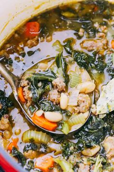 a spoon filled with soup and vegetables on top of a wooden table next to an instagram post