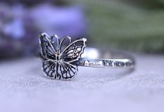 This listing is for one beautifully intricate and dainty sterling silver butterfly stacking ring. It features one detailed butterfly fired onto a elegant and feminine dotted ring band. This ring is perfect for all butterfly lovers and makes a great spring and summer ring! It looks great solo or stacked with other rings and bands. - Choose your size at check-out! - Butterfly measures 9mm by 9mm. - Ring band is 1.5 mm tall. Want the entire butterfly stacking set? Check it out here: https://www.ets Delicate Adjustable Butterfly Promise Ring, Dainty Adjustable Silver Butterfly Ring, Adjustable Silver Butterfly Ring, Elegant Silver Jewelry With Butterfly Print, Tiny Sterling Silver Butterfly Jewelry, Silver Butterfly Rings With Butterfly Charm, Tiny Butterfly Sterling Silver Jewelry, Dainty Sterling Silver Butterfly Open Ring, Silver Ring With Butterfly Charm For Wedding