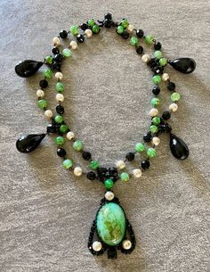 An unusual and very rare early 1960's Necklace created by Roger Scemama for Christian Dior . This is such a beautiful and stunning rare necklace with gorgeous colour combination of green and black poured glass on a japanned metal structure makes this a stand out example of the early work of Roger Scemama  from the early 1960s . The last few pictures are taken from the book Adorning Fashion by Deanna Farneti Cera, page 305 listing the brooch as a signed Christian Dior 1960 and also from an auctio Luxury Green Cabochon Necklace, Elegant Evening Cabochon Necklaces, Handmade Necklaces For Evening, Handmade Round Necklaces For Evening, Green Beaded Evening Jewelry, Vintage Long Necklace For Evening, Handmade Evening Pendant Necklaces, Handmade Pendant Necklaces For Evening, Handmade Evening Pendant Necklace