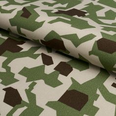 a green and brown pattern on fabric