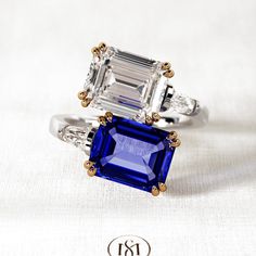 an emerald and sapphire ring with diamond accents