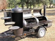 an outdoor bbq grill is shown in the middle of a field with trees and grass