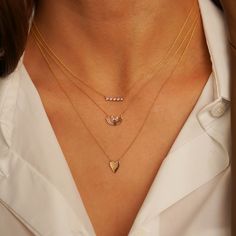 This petite diamond bar necklace is the perfect everyday staple. Simple and classic on its own, it is also a great layering necklace. This dainty 14 karat gold and diamond bar necklace features white round diamonds bezel set in a row. The bezel settings wrap around each diamond providing not only a modern look but also a protective setting. This piece is a contemporary twist on the classic diamond bar necklace. The adjustable chain means this beauty will look perfect with any neckline and makes Everyday Diamond Birthstone Necklace, Minimalist Everyday Diamond Necklace With Accents, Everyday Yellow Gold Diamond Bar Necklace, Everyday Minimalist Diamond Necklace With Accents, Everyday White Gold Diamond Necklace, Everyday Gold Bar Necklace With Diamond, Minimalist Everyday Necklace With Diamond Accents, Dainty Yellow Gold Diamond Bar Necklace, Everyday Dainty Necklace With Single Cut Diamonds