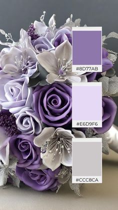 a bridal bouquet with purple and white flowers on the bottom, in shades of gray