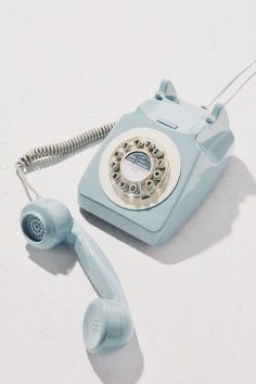 an old - fashioned rotary phone is laying on the floor