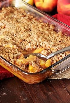 a glass casserole dish filled with fruit and oatmeal crumbles