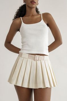 This skirt will be on repeat in your wardrobe. A crisp, fresh take on the micro mini with built in bloomers. You can pair this with practically anything.Features an invisible side zipper and built in fabric covered belt for a pop of color.These perfect pleats stay flat. Low waist skirt that sit below the navel. Hits at the hip for that micro mini length. Skirt grazes your upper thigh.Cotton / Poly blend. Dry Clean Only.Made in New York City. Barbie Princess Charm School, Low Waist Skirt, Princess Charm School, Belted Mini Skirt, Charm School, Micro Mini Skirt, Barbie Princess, Clothing Details, Cardigan Sweater Jacket