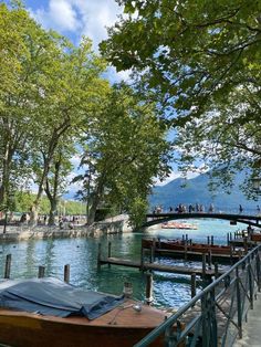 a boat is docked on the water near some trees