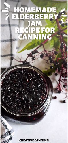 a jar filled with jam sitting on top of a table next to some leaves and berries