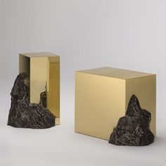 two golden cubes sitting next to each other