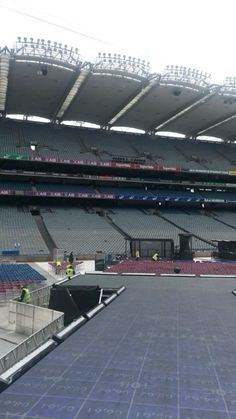 an empty stadium filled with lots of seats and tarp covering the floor in front of it