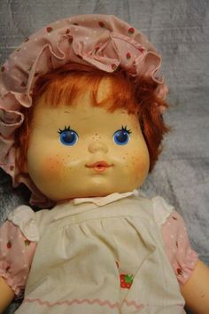 an old doll with red hair and blue eyes