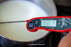 a digital thermometer is being used to check temperature in a pan on the stove