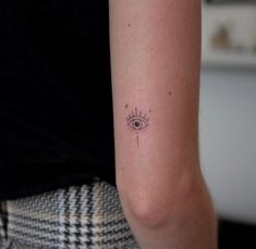 a woman's arm with a small tattoo on the left side of her arm