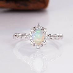 Gorgeous vintage inspired Australian opal ring ✧ Sterling silver (925) or 14K Gold or 14K Rose gold ✧ Accented with natural quartz diamonds This gorgeous, timeless ring features a stunning Australian opal and natural crystals. ✧ Stone: Natural Gemstone  ✧ Shape: Oval ✧ Carat Weight: 0.53ct. (approx.) ✧ Gemstone Origin: Australia  ✧ Sizes 2.75-12.25 ✧ This ring set will arrive ready to gift in a Kherish Box. ✧ Due to the nature of the handmade process, each piece may slightly vary in color, size, Silver And Opal Ring, Dainty Opal Birthstone Ring For Anniversary, Classic Ethiopian Opal Ring As A Gift, Elegant Ethiopian Opal Ring, Silver Opal Gemstone Ring In 14k Gold, Silver Opal Birthstone Ring In 14k Gold, Delicate Sterling Silver Opal Ring For Anniversary, Silver 14k Gold Opal Promise Ring, Silver Opal Ring In 14k Gold For Promise