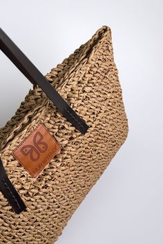 Embark on a journey of coastal elegance with our stunning Aria woven raffia tote, embodying the essence of Mediterranean living. Meticulously handcrafted with detailed raffia weaving and featuring sturdy brown handles, this tote exudes an aura of refined sophistication. Embrace the enchanting spirit of the Mediterranean with this indispensable accessory, a harmonious fusion of craftsmanship and style destined to captivate admirers. Details: Height: 14" Width: 18" Authentic raffia Handmade product. Luxury Handwoven Natural Fiber Beach Bag, Handwoven Brown Natural Fiber Beach Bag, Eco-friendly Beach Bag With Woven Leather And Natural Fiber, Eco-friendly Brown Handwoven Beach Bag, Mediterranean Living, Italy Gift, Eco-friendly Rattan Shoulder Bag With Open Weave, Woven Raffia, Comfortable Sneakers