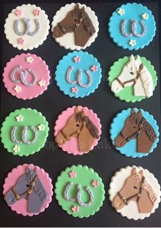 decorated cupcakes in the shape of horses and horseshoes on a black background