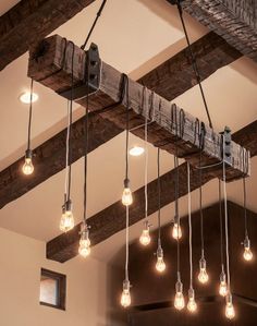 the light bulbs are hanging from the beam in the room, which is decorated with wood beams