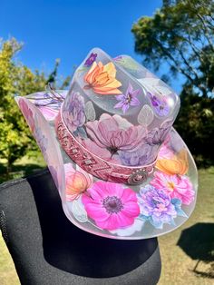 This is a wearable hat. If you're looking for a show stopping piece, something incredibly unique, and one of a kind, this is the one! It's the same size as my standard one size hats, however because it's acrylic, no adjustable tie to make size smaller. Flowers are these beautiful fine line stickers and all greenery is hand painted. It's all coated in a think layer of resin to protect design. Unique Hat For Rodeo And Kentucky Derby, Unique Hats For Kentucky Derby, Unique Hats For Kentucky Derby And Country Events, Custom Wide Brim Multicolor Hat, Custom Multicolor Wide Brim Hat, Custom Multicolor Brimmed Hat, Whimsical Hat For Kentucky Derby, Custom Multicolor Hat With Curved Brim, Custom Multicolor Flat Brim Hats