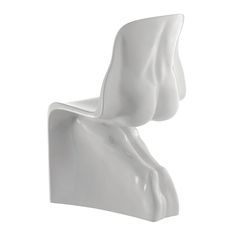 a white chair that is shaped like a human head and has one leg bent up