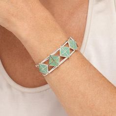 Jay King Gallery Collection Alicia Turquoise Inlay Cuff Bracelet  Gorgeous, green Alicia turquoise inlaid in a fun, geometric design, gives this handcrafted, sterling silver cuff bracelet a chic, contemporary vibe. From Jay's exclusive Gallery Collection.       Approx. 6-3/4"L x 3/4"W; fits 6" to 7" wrist     Stamped .925     Split-top cuff bracelet has green turquoise triangles inlaid in square pattern across top     Sides taper to ends   Stone Information       All sizes and weights approximat Modern Turquoise Bracelet Jewelry, Modern Turquoise Bracelet, Geometric Green Jewelry Gift, Green Geometric Jewelry For Gifts, Green Geometric Jewelry Gift, Green Geometric Jewelry For Gift, Modern Green Geometric Jewelry, Modern Turquoise Cuff Bracelet For Gift, Modern Turquoise Bracelets As Gift