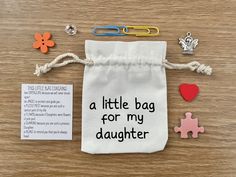 a little bag for my daughter with magnets and paper clips on the table next to it