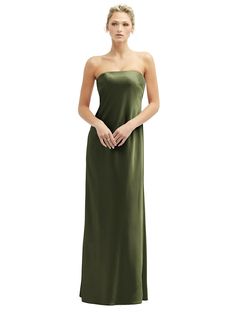 a woman in a long green dress is standing with her hands on her hips and looking at the camera