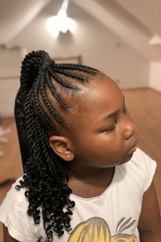 This charming hairstyle has neatly braided cornrows that start at the front of the head and come together at the top, each row showing a tidy and smooth look. From where they join, the braids flow down in a loose, curly ponytail, giving a fun and different twist to the classic cornrow style. Perfect for special events or everyday use, this hairstyle is - Click to see more of 20 Cute Cornrow Hairstyles for Children and follow us for more hairstyle ideas. // Photo Credit: Instagram @m.v_hairstyle Braided Cornrows