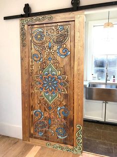 a wooden door with intricate designs painted on it