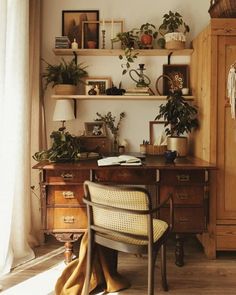 a desk with a chair and some plants on it