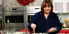 a woman standing in a kitchen preparing food