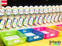 colorful baskets are lined up in front of a wall with numbers and letters on them