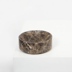 a marbled wooden ring sitting on top of a white surface