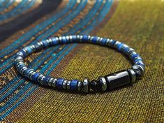 🎁 Embrace sophistication with this exquisite Blue Lapis Lazuli men's bracelet featuring handcrafted Black Tourmaline and Hematite jewelry in a minimalist style, making it an ideal birthday gift idea. This elegant piece combines style and craftsmanship to create a unique accessory that adds a touch of charm to any ensemble. Material details: -8mm Black Tourmaline -4mm Lapis Lazuli -4mm Hematite PACKAGING * Each piece of our bracelet is packaged in a black gift box with ribbon, perfect for gift-g Hematite Bracelets With Natural Stones For Gift, Handmade Hematite Bracelets As Gift, Adjustable Magnetic Jewelry With Round Beads, Magnetic Adjustable Beaded Bracelets As Gift, Adjustable Magnetic Beaded Bracelets As Gift, Spiritual Hematite Jewelry For Gifts, Spiritual Hematite Jewelry As Gift, Magnetic Hematite Beaded Bracelets Gift, Blue Hematite Jewelry For Gift