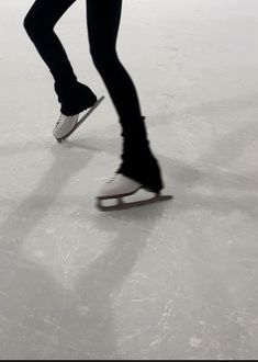 a person is skating on an ice rink