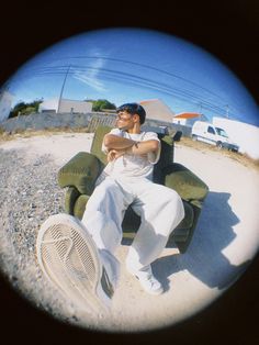 a man sitting in a lawn chair with his arms crossed and legs crossed while looking at the camera