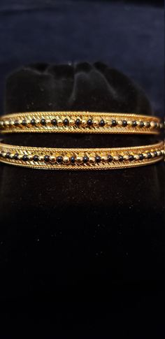 "* Handcrafted Gold Plated 2 Bangle Set. Sold as a set. * Bangles with prettY Black and gold color beads. * High Quality 22 K Gold Plated- 2 Bangle set * Size 2.6 has 2.40\" inner circle diameter; size 2.8 has 2.53\" inner circle diameter Gorgeous gold-plated bangle/ bracelet best exemplifies the careful craftsmanship done on it -- a specialty at Nemali Jewelry. It has a special tone of elegance attached to it. The intricate handmade design of the bangle/bracelet set gives it a fresh and origina Gold Beaded Bangle For Wedding, Gold Beaded Bangle As Gift, Gold Beaded Bangle For Gift, Festive Gold Beaded Bracelets With Round Beads, Gold Beaded Bracelets With Tiny Beads For Party, Festive Yellow Gold Bracelets With Round Beads, Gold Beaded Bangle Jewelry, Gold Beaded Bangle Bracelet For Celebration, Gold Bracelet With Round Beads For Festive Occasion