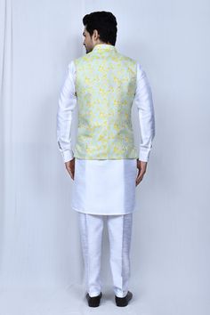 Light blue sleeveless bundi with floral print and mandarin collared neckline. Paired with full sleeve white kurta and straight pant.
Components: 3
Pattern: Printed
Type Of Work: Floral
Neckline: Mandarin collar
Sleeve Type: Bundi: Sleeveless, Kurta: Full sleeves
Fabric: Art Silk
Color: Blue
Other Details: 
Front button detailing
Elasticated waistband
Side pockets
Occasion: Sangeet - Aza Fashions Nehru Jacket For Men, Sleeveless Kurta, Kurta Set For Men, White Kurta, Nehru Jackets, Fashion App, Kurta Set, Full Sleeves, Blue Art