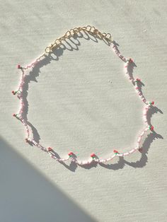 🍒 Cute and dainty light pink beaded necklace with red cherries. 🌸 This necklace can be worn anywhere in length from 14 to 17 inches, making it adjustable to fit any occasion. It closes with a lobster clasp and has an extender of 2.5 inches. 🍒 The extender and lobster clasp are gold plated. 🌸 This necklace is handmade carefully. To preserve it, avoid wetting it. Cherry Beaded Round Bead Jewelry, Trendy Pink Necklace With Tiny Beads, Adjustable Pink Beaded Chain Necklace, Cute Pink Summer Necklaces, Casual Pink Beaded Necklaces, Casual Pink Beaded Chain Necklace, Pink Tiny Beads Necklace For Summer, Summer Pink Necklaces With Tiny Beads, Casual Pink Necklace With Tiny Beads