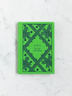 a green book sitting on top of a white counter