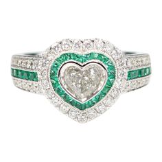 Brilliant Art Deco Style Ring Very special & unique, 18k White Gold 8.30 grams. Total all Diamonds 1.18 carat ( center stone is heart shape cut Diamond 0.44 carat IJ-I1 ) Emeralds total 0.71 carat. overall design area size on the top is, 13 mm. Finger size 7. all the small diamonds are HI-SI all stones are fully natural and none treated ! R2422H60x53 Luxury Heart Cut Emerald Promise Ring, Luxury Green Heart Cut Rings, Gia Certified Heart Cut Diamond Ring, Gia Certified Heart Diamond Rings, Formal Heart Cut Emerald Ring, Gia Certified Heart Shaped Fine Jewelry Ring, Heart-shaped Diamond Ring With Center Stone, Fine Jewelry Heart-shaped Gia Certified, Heart-shaped Gia Certified Ring For Anniversary