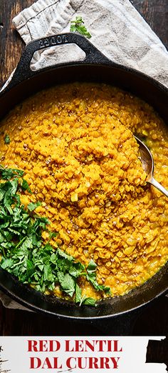 red lentil dali curry in a cast iron skillet on a wooden table