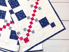 two blue and red quilts sitting on top of each other