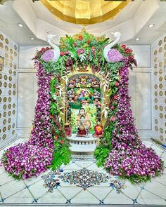 an elaborate floral display in the middle of a room filled with flowers and other decorations