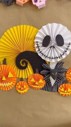 paper fans decorated with jack skellingy faces and pumpkins