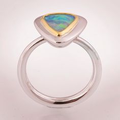 "A handmade opal ring made with a sleek 14k white gold band and a 22k yellow gold bezel. The ring is set with a top quality natural Australian opal with bright colors all over. -------> A Video is available here - https://youtu.be/4C-Q-VQ-dkk The ring has a pleasant, substantial weight and an amazingly comfortable rounded band. The ring can be made with any of the available loos stones seen in the pictures - Opal #1 Dimensions - 9.1mmX7.1mmX3.6mm, 1.45ct Australian 2800$ Opal #2 Dimensions - Modern Sterling Silver Opal Ring For Wedding, Opal Rings With Polished Finish For Formal Occasions, Formal Opal Rings With Polished Finish, Sterling Silver Opal Ring With Bezel Setting, Opal Ring With Bezel Setting, Formal Opal Ring With Polished Finish, Modern Opal Ring With Bezel Setting, Modern Oval Opal Ring With Bezel Setting, Modern Opal Jewelry For Anniversary