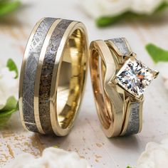 two wedding rings with gold and silver bands, one has a diamond in the center