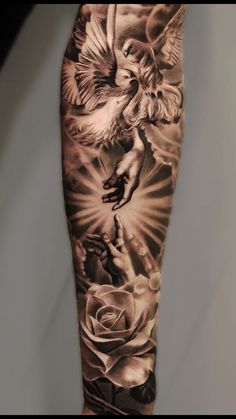 a man's arm with an angel and roses tattoo on it